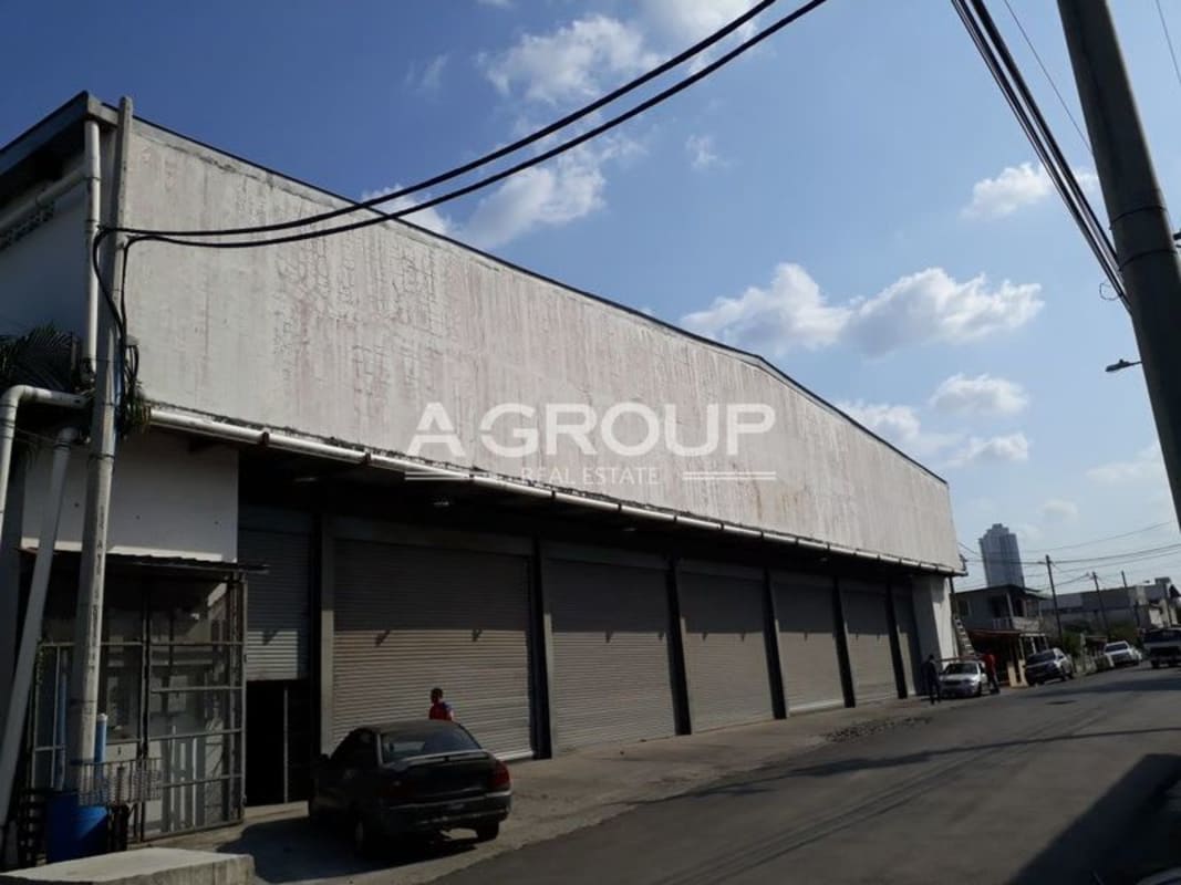 Exterior of large concrete warehouse with rolling doors truck loading area in Llano Bonito Juan Díaz Panama