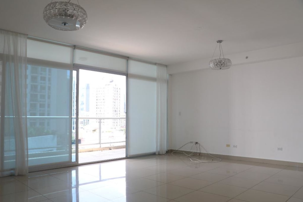 Bright open living area with AC, balcony access and modern tile floors at PH Cangrejo Bay Panama