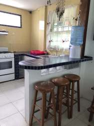 Traditional tiled kitchen with appliances in Caribe home Isla Grande Panama for sale