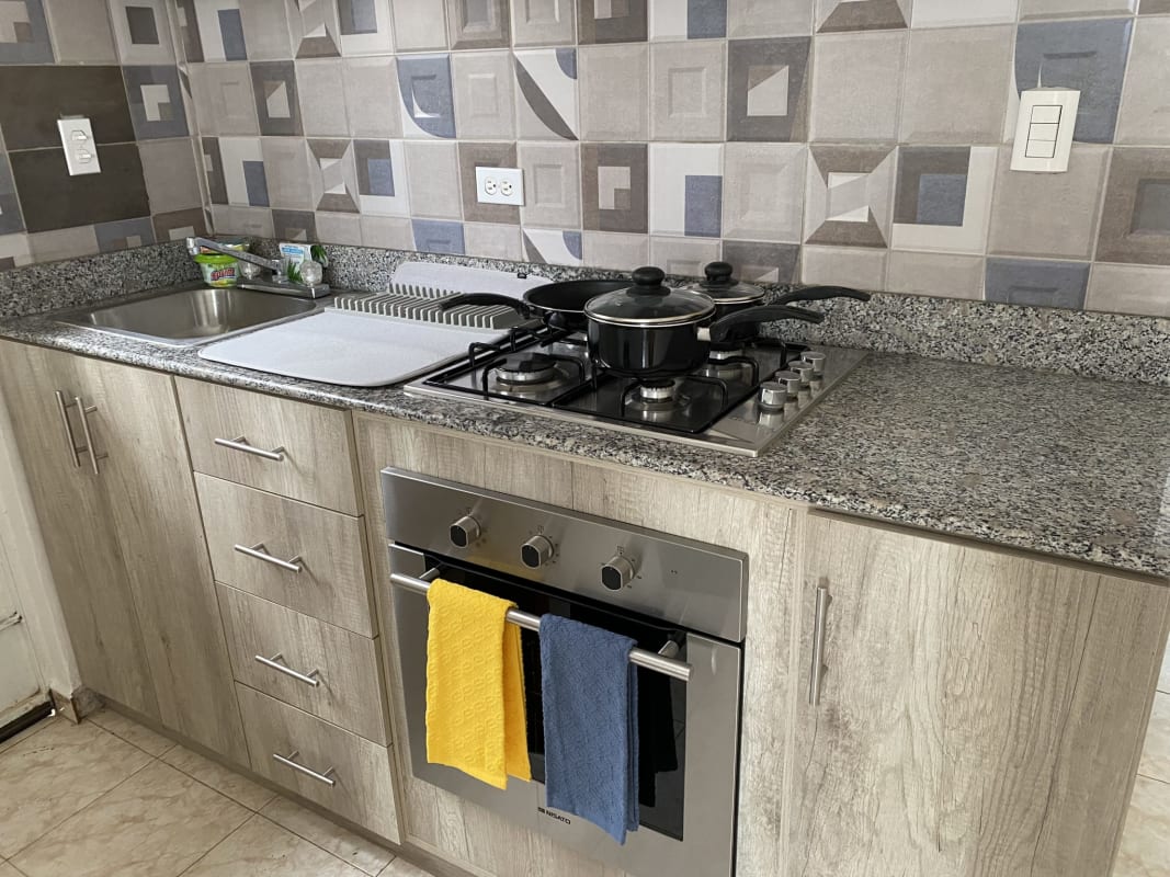 Kitchen with granite countertops, stove, oven, modern cabinets Puerta del Este Panama City