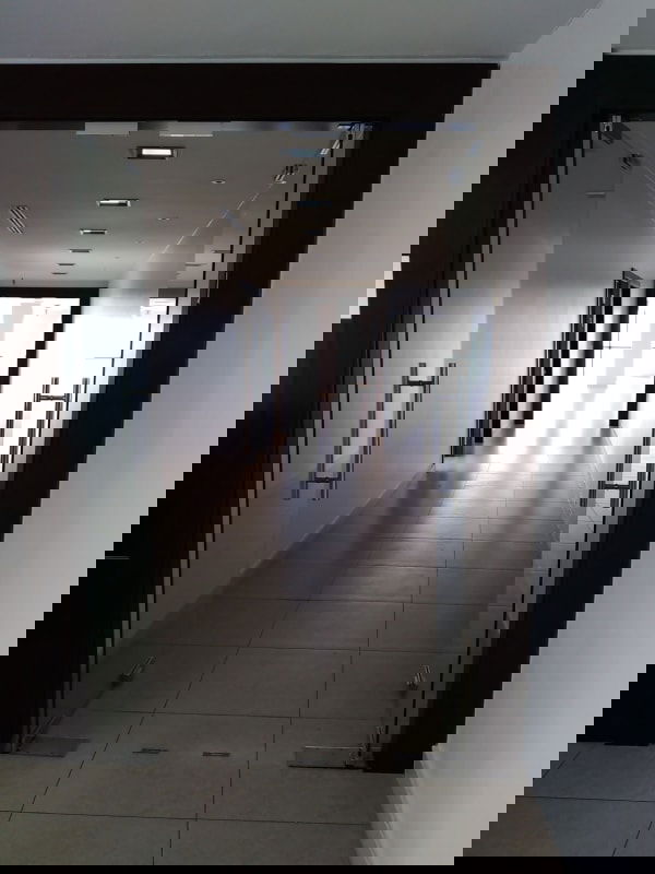 Modern interior hallway with glass doors and tile floors in PH BAC Tower Avenida Balboa