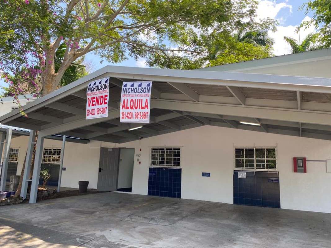 Covered carport exterior view with security bars and for sale signage at La Boca Ancón Panama