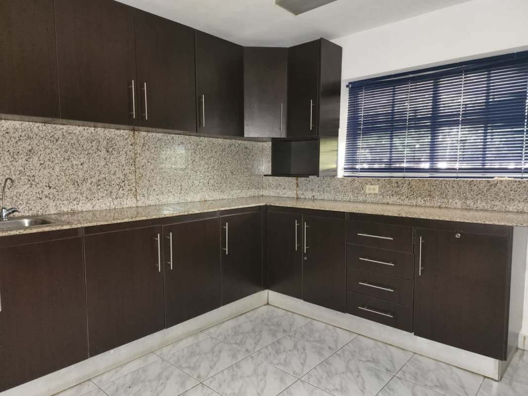 Granite countertop dark wood cabinet kitchen inside office building Urbanización La Boca Ancón Panama
