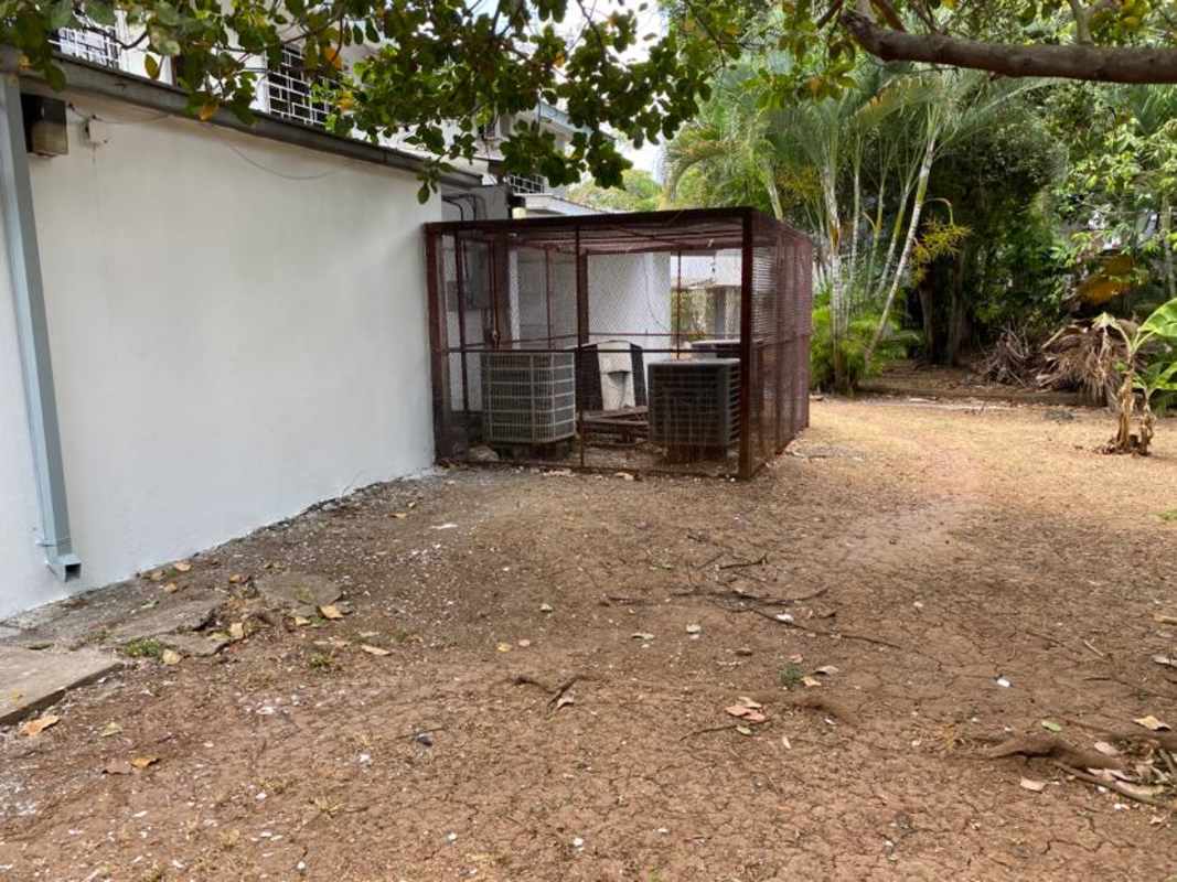 Backyard utility zone with air conditioning units fenced in tropical garden Urbanización La Boca Panama