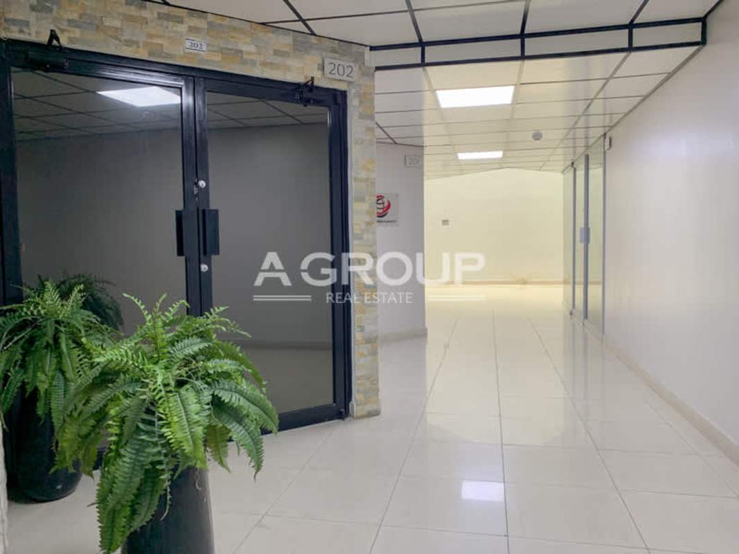 Glass door hallway with potted plants PH Bay Mall Avenida Balboa commercial office Panama City