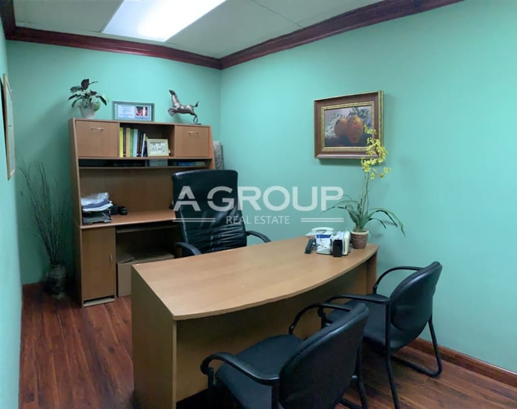 Small private office with green walls wooden desk PH Bay Mall Avenida Balboa Panama