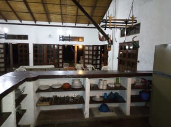 Rustic Caribbean kitchen with open shelving and bar counter Isla Grande Panama