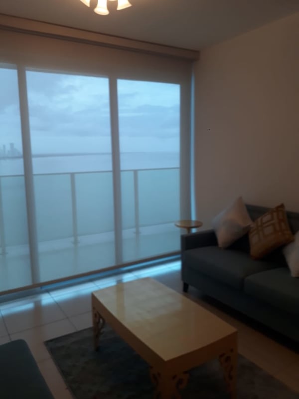 Living and dining room with large windows ocean views PH Oasis Punta Pacifica Panama