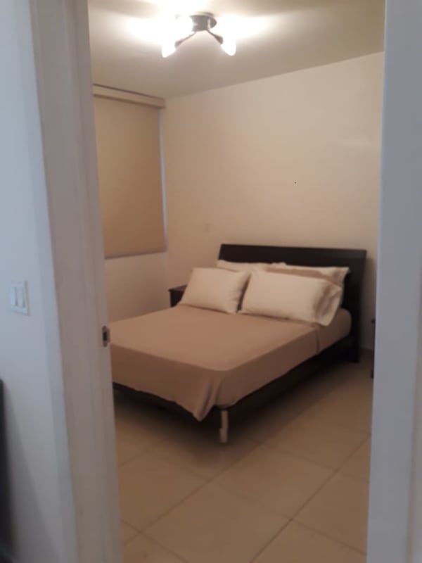 Bedroom with window overlooking Pacific Ocean and walk-in closet in Oasis on the Bay Panama