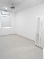 Minimalist empty bedroom with tiled floor, AC and closet at Rincon del Paraiso Panama