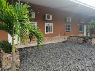 Exterior shot of low-rise residential buildings with palm landscaping in Rincon del Paraiso Rio Hato