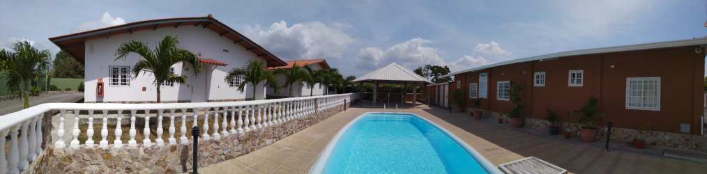 Swimming pool and gazebo in tropical residential setting at Rincon del Paraiso Rio Hato