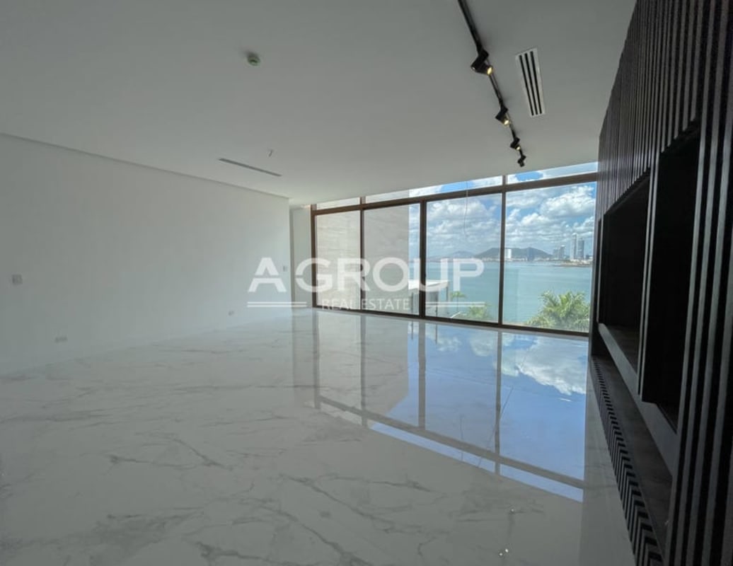 Luxury master bathroom with marble finishes, Jacuzzi tub and skyline view in Ocean Reef penthouse