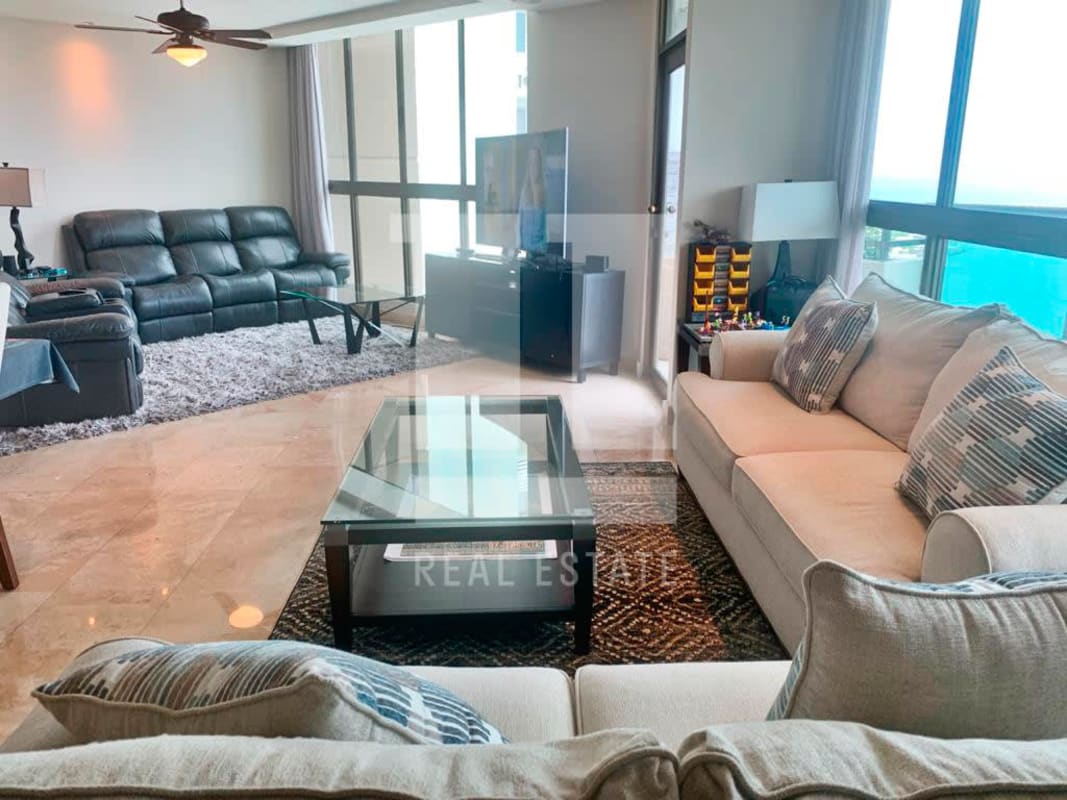 Spacious living room with marble floors, large windows and balcony access in PH Ocean Park Punta Pacifica