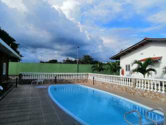 Outdoor swimming pool surrounded by palm trees ideal for residents in Río Hato