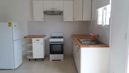 Simple fitted kitchen with appliances double sink ceramic tile counters in Río Hato rental apartment