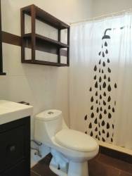Modern bathroom with shower, vanity, and warm water system in Coclé Panama rental apartment