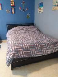 Kitchen with wood cabinetry, appliances in beach rental house Coronado Panama