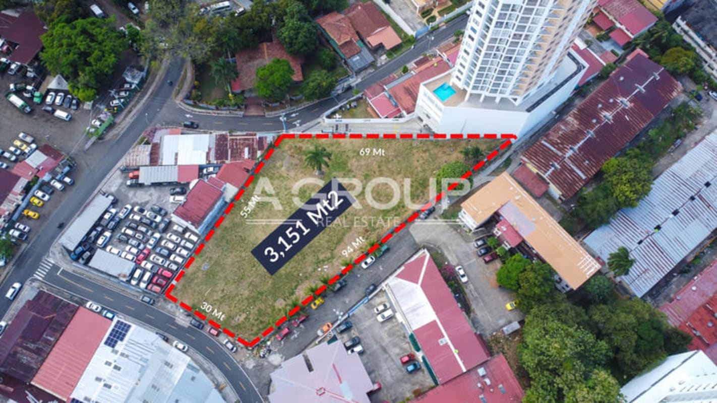 Marked triangular urban land ready for development in growing central Panama neighborhood