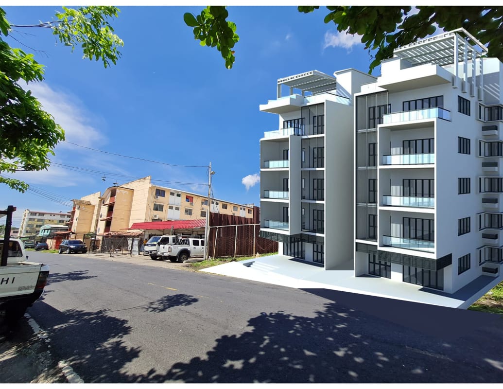 Modern apartment tower next to vacant lot with glass balconies and urban surroundings Panama