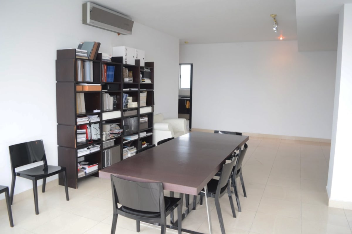 Dining area near large window with panoramic Pacific Ocean and Panama City view at PH Window Tower