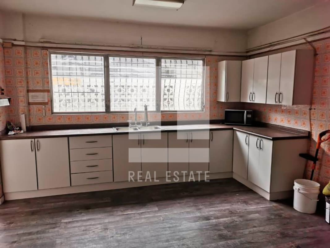 Two story white house with brick accents balcony garage Casa Dudley Obarrio Panama