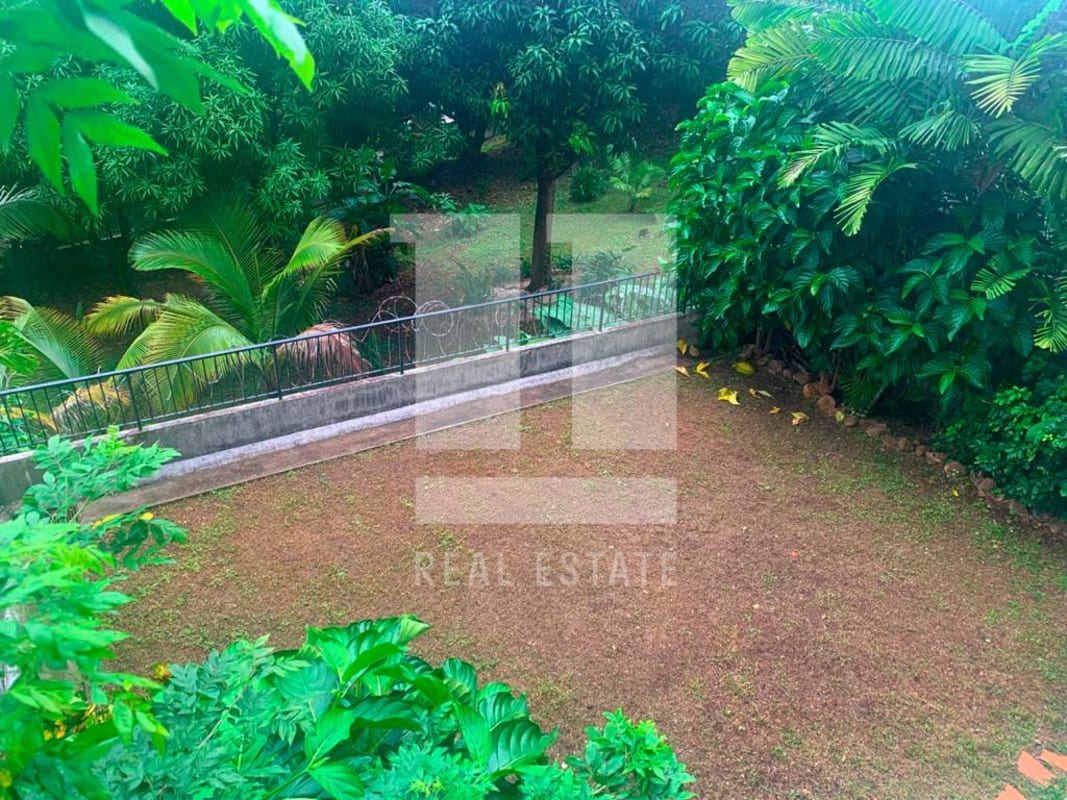 Multi-level living space with chandelier and glass folding doors in Dos Mares house Panama