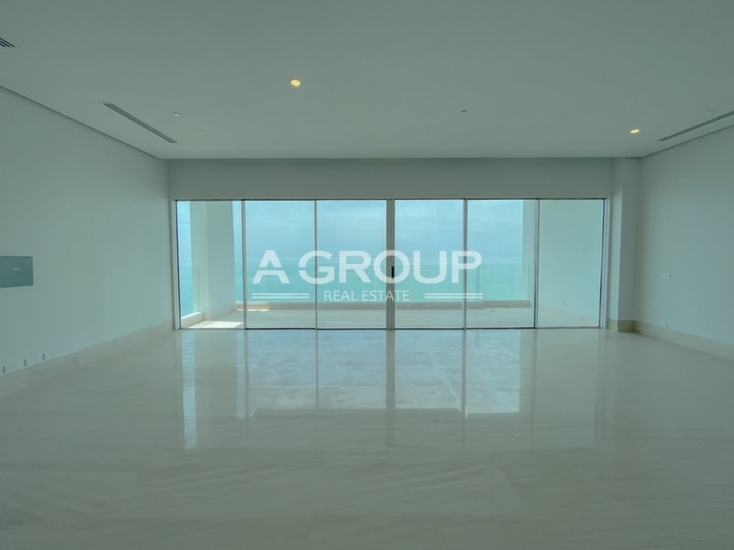 Modern living room in Ocean Pearl Ocean Reef with floor-to-ceiling windows and ocean marina views