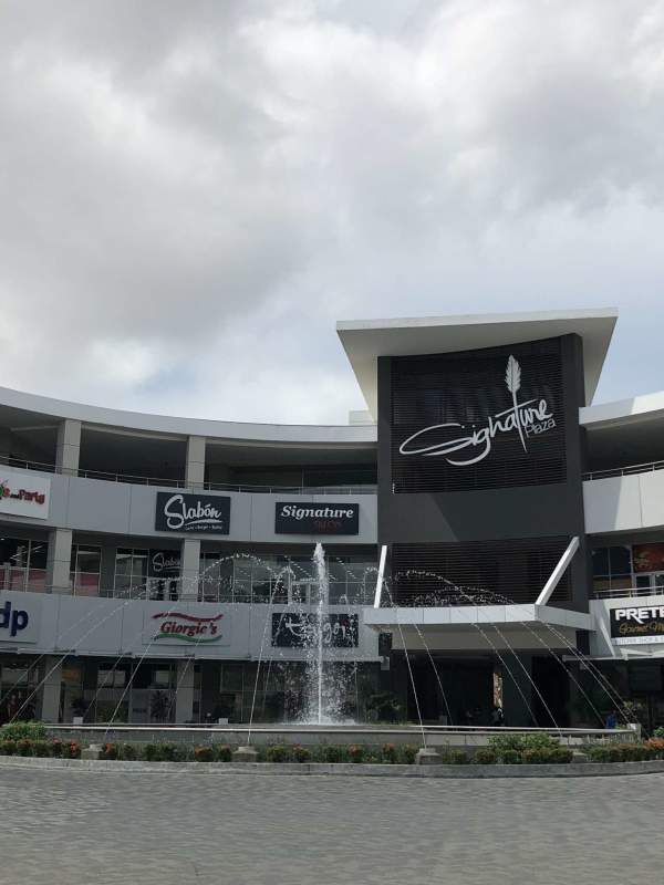 Interior view of grey semi-finished commercial store space with tiled floors at Signature Plaza Panama