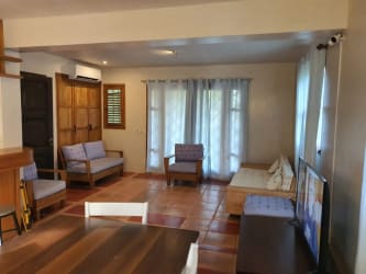 Tropical bedroom with vaulted ceiling, balcony, ocean view at Ocean Loft Pedasi beachfront villa Panama