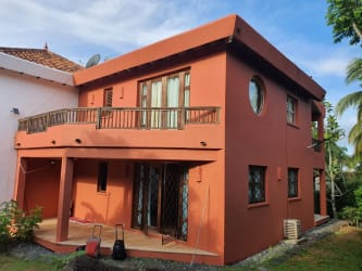 Exterior view two-level beachfront Mediterranean-inspired house with balcony at Ocean Loft Pedasi Panama