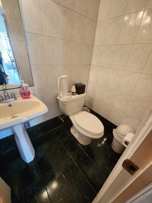 Traditional style bathroom with glass shower, vanity sink, tile walls at PH Terrazas del Cangrejo