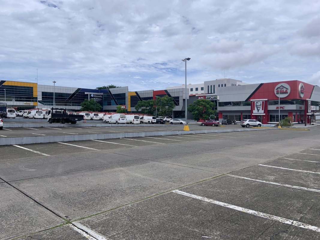 Wide view parking and storefronts shopping plaza Villa Lucre investment Panama