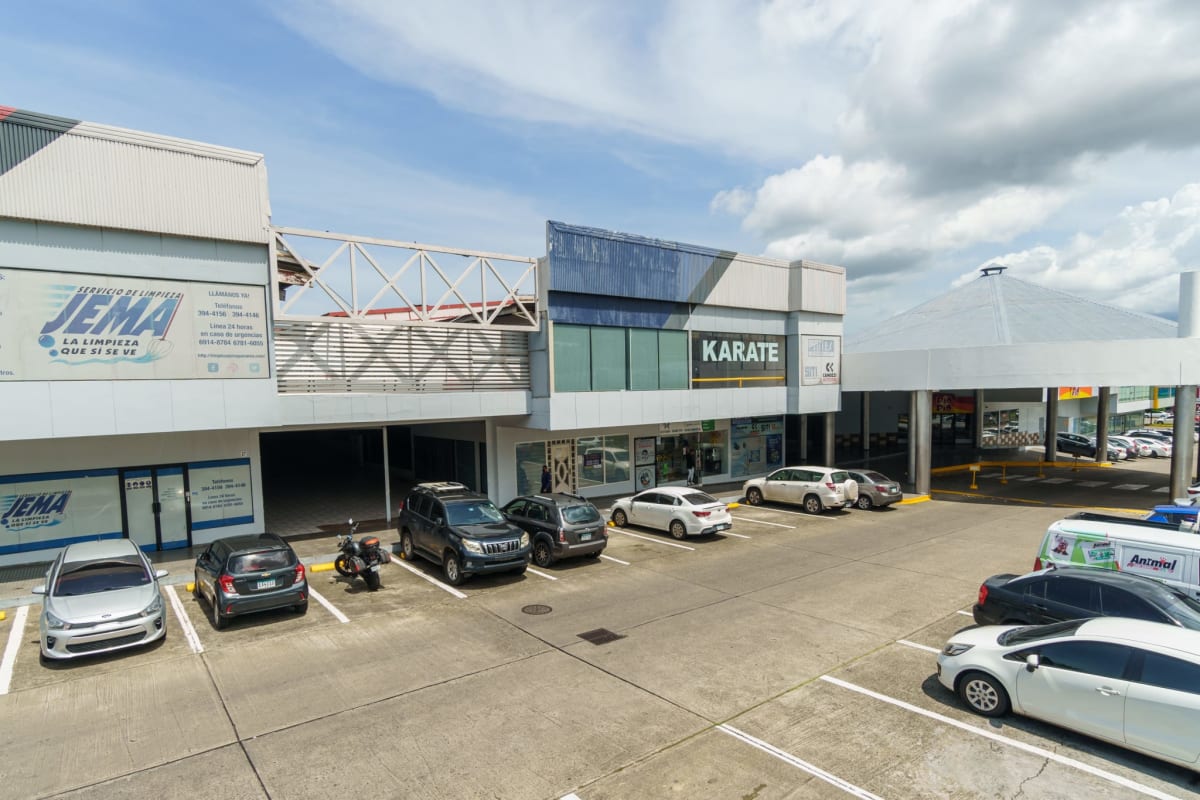 Side view of Plaza Conquistador retail units and storefront signage in Villa Lucre Panama