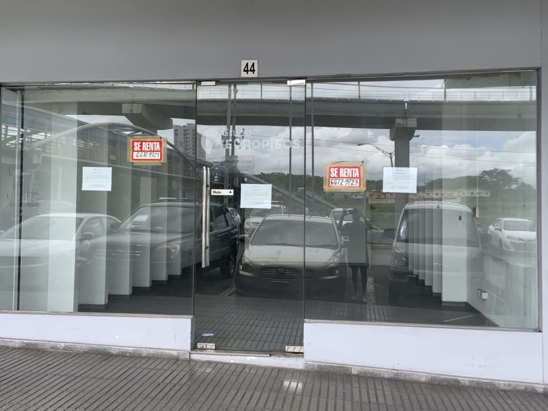 Glass retail frontage at shopping plaza with reflections Villa Lucre Panama