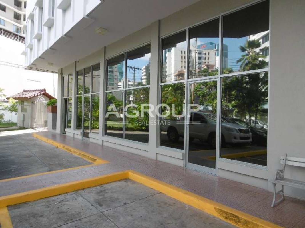 Street view of modern commercial building with glass windows in Marbella business area Panama