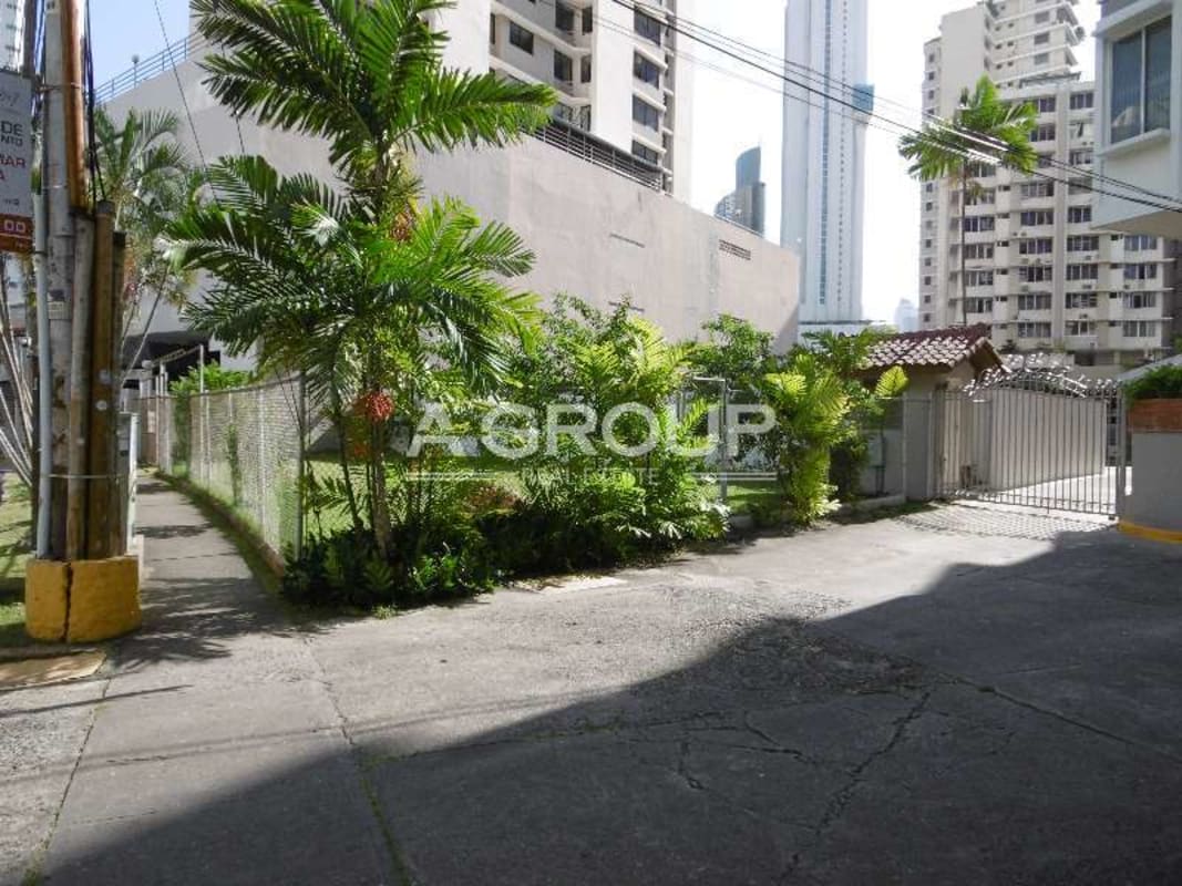 Secure gated access with palm trees surrounding commercial land and building Marbella Panama