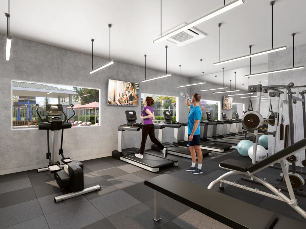 Apartment gym with equipment and large windows at Torres de Cantabria Tocumen Panama City