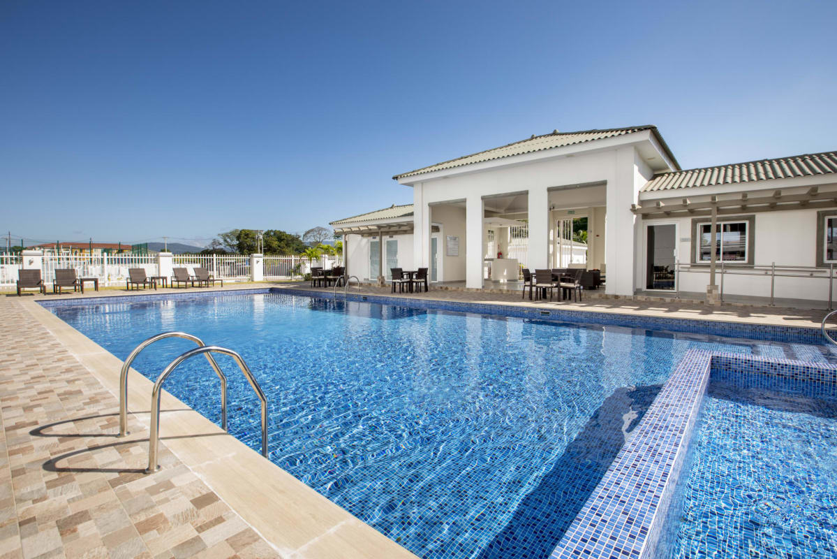 Modern bedroom with dark blue accent wall large window at Torres de Cantabria Tocumen Panama
