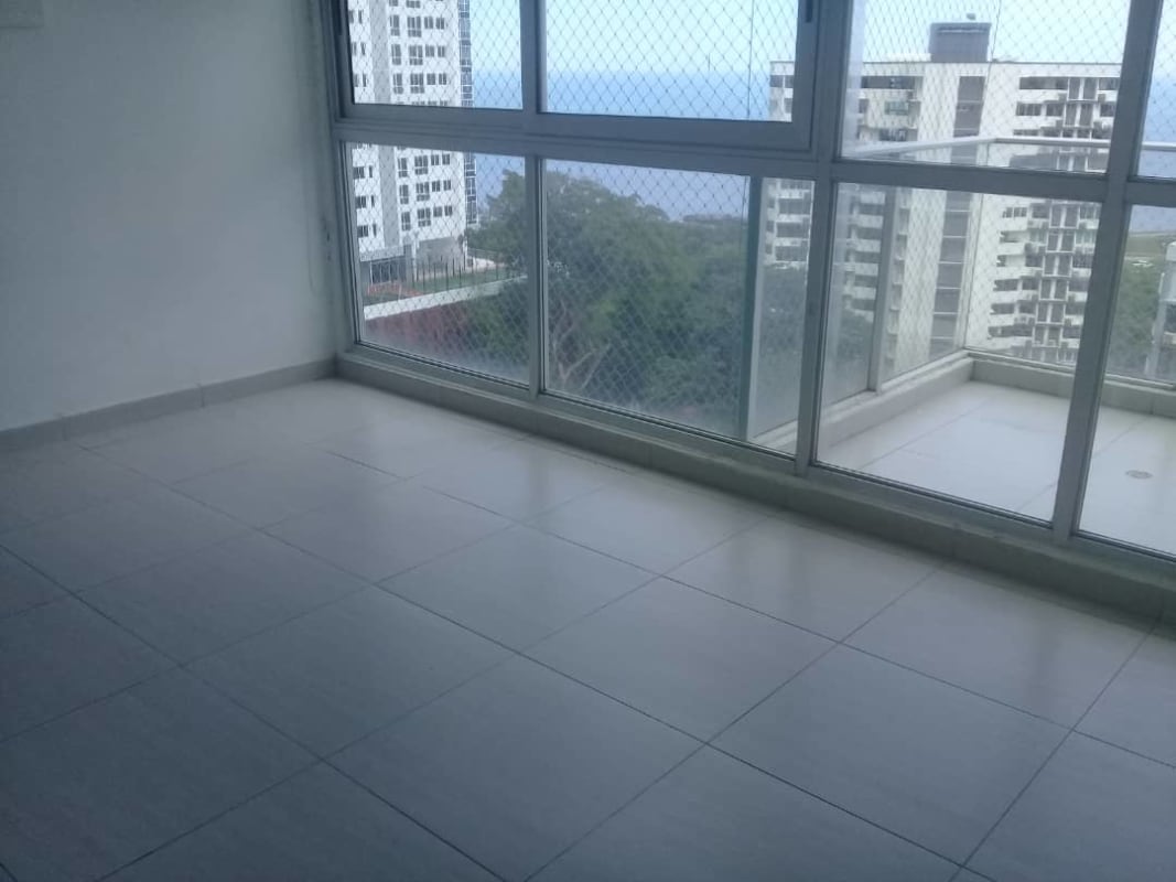 Bedroom with panoramic windows and ocean-city views in PH Le Mare Panama City
