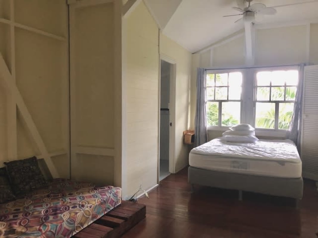 Tropical two-story house with green siding stone foundation Herrick Heights Panama