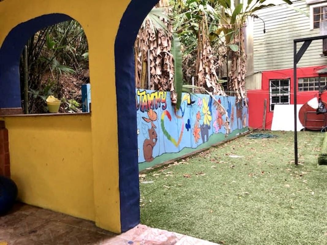 Colorful outdoor kids play area with turf and mural wall Herrick Heights Panama Ancon