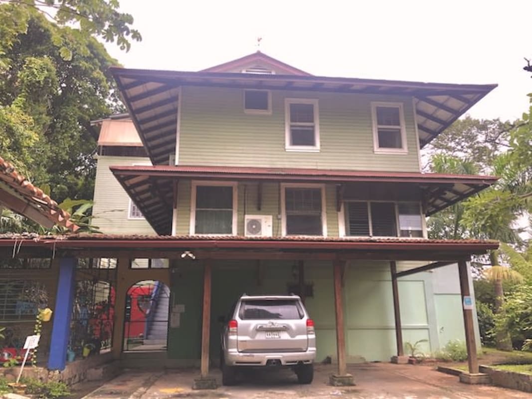 Rustic bedroom with vaulted ceiling, wood floors, large windows and bright light Herrick Heights Ancon Panama