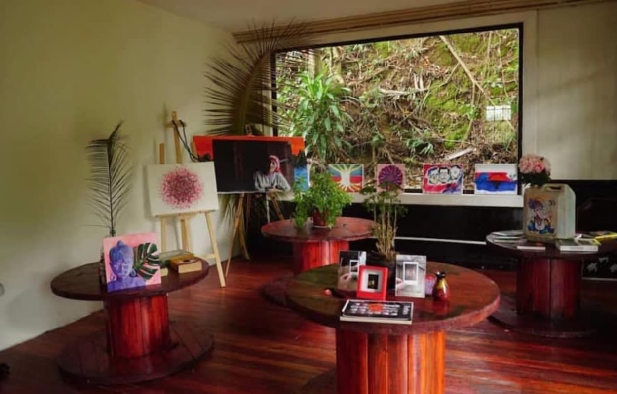 Light green multi-story tropical house with balconies and lush greenery at Herrick Heights Ancon Panama