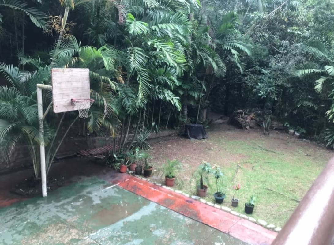 Rustic brick barbecue grill patio overlooking tropical forest in Herrick Heights Ancon Panama