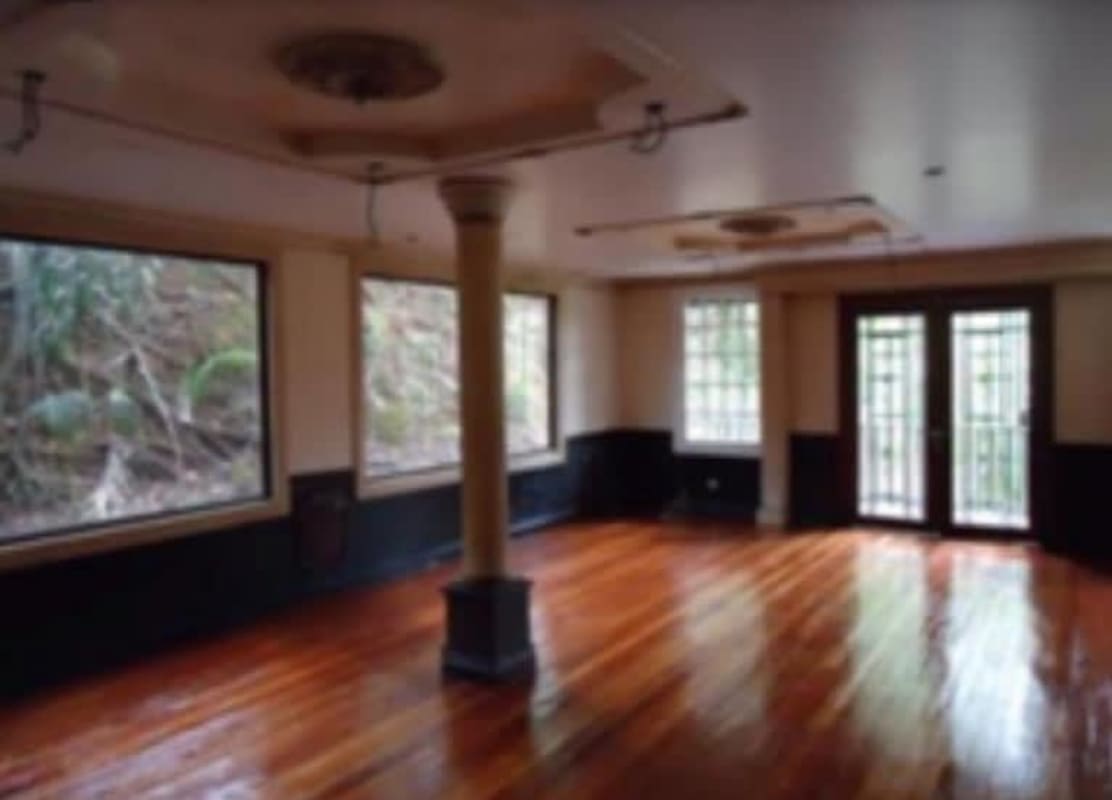 Balcony with hammock overlooking lush greenery and Panama City skyline in Ancon neighborhood