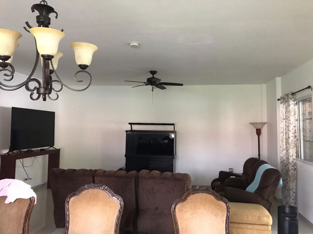 Living room with large windows and traditional furnishings in El Doral Betania Panama