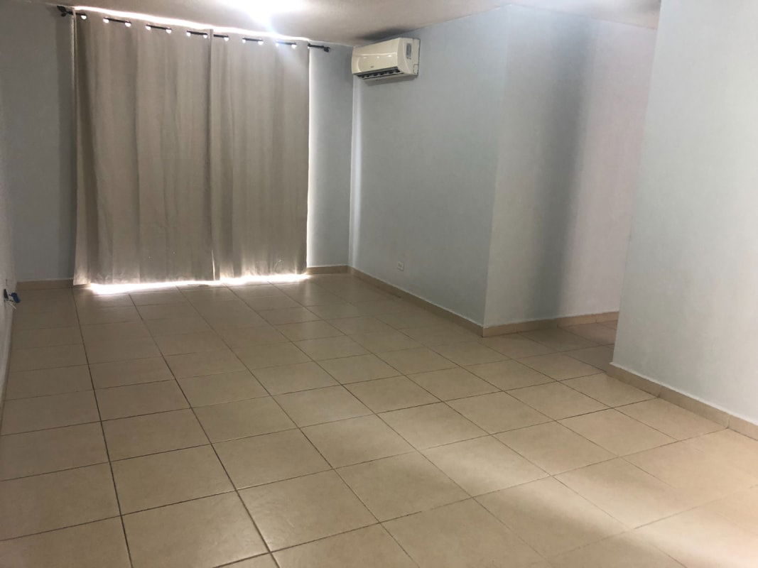 Open living dining room with tiled floors and balcony access Mystic Village Don Bosco