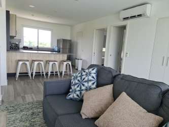 Outdoor pool area with garden lounge at Punta Chame beach condo Panama for sale