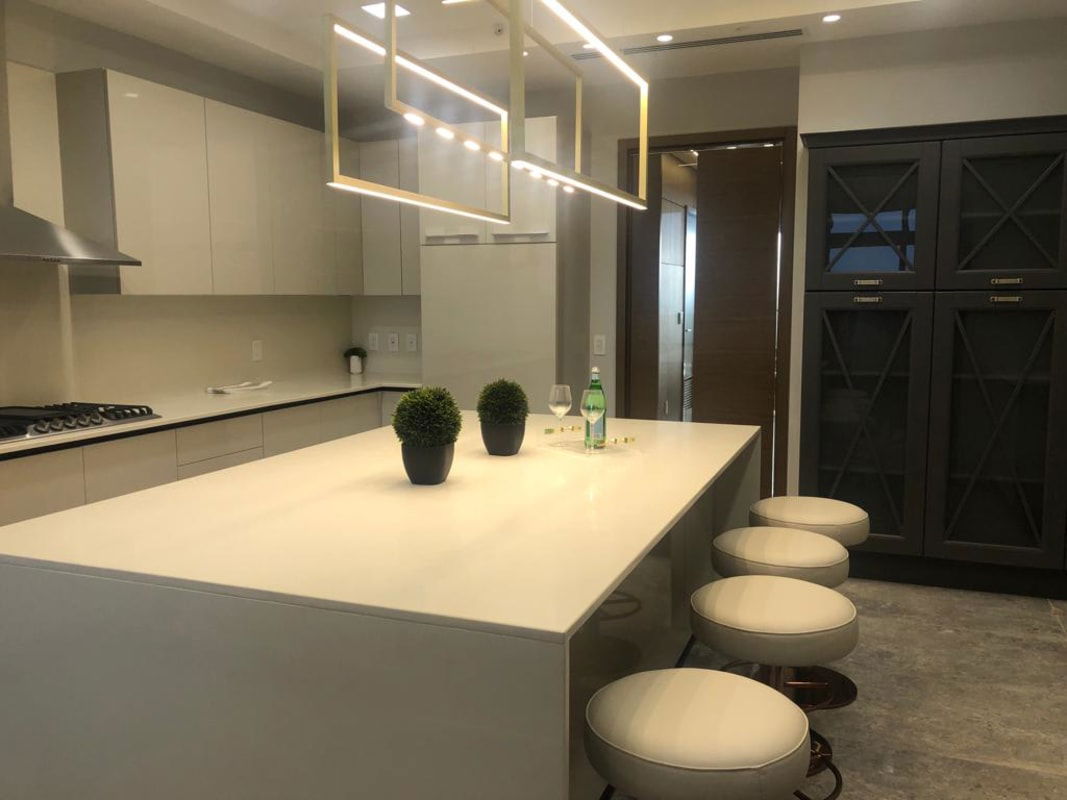 Modern gourmet kitchen with marble island cabinetry pendant lighting Empire Residences Panama